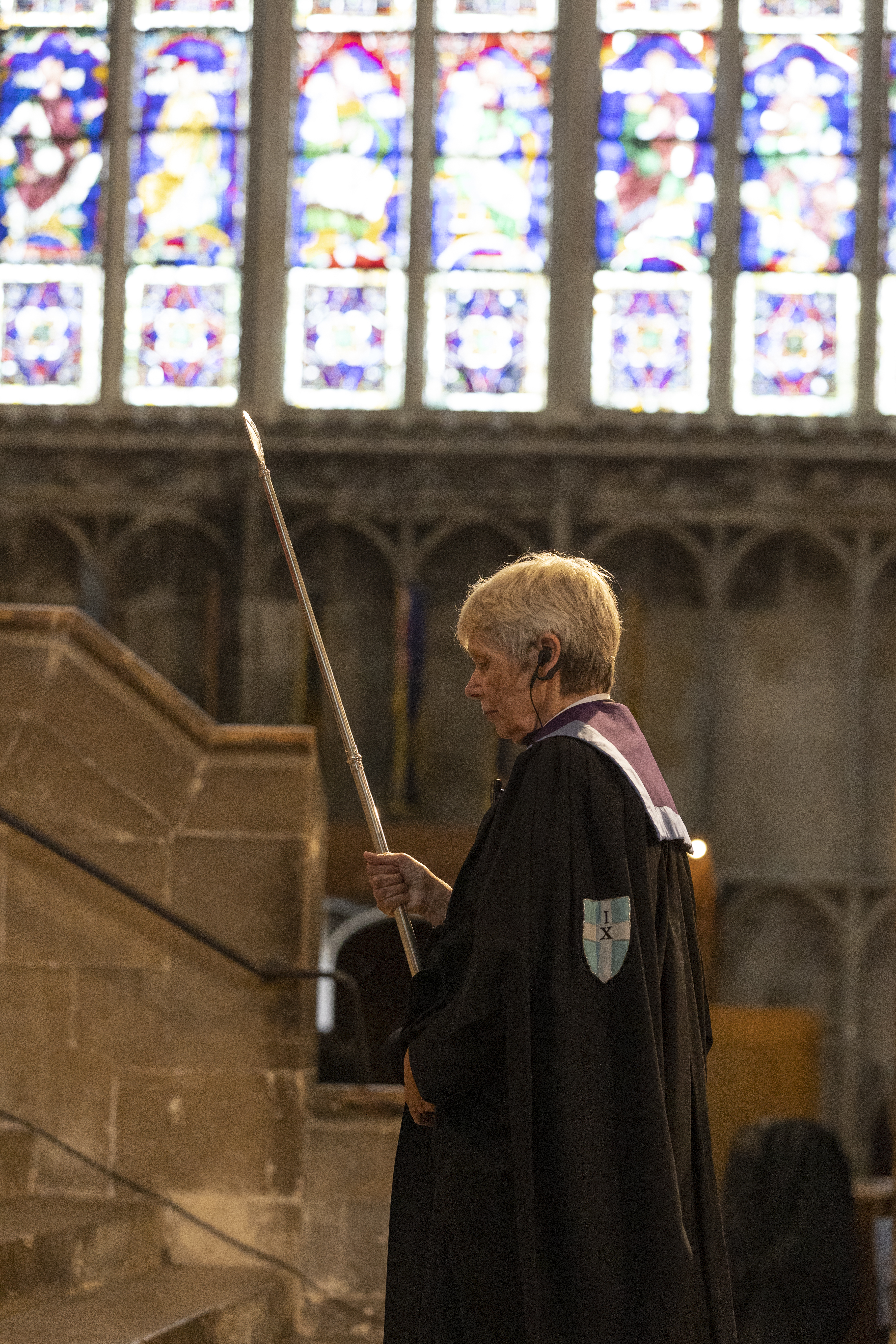 Virger Processing in front of Stained Glass